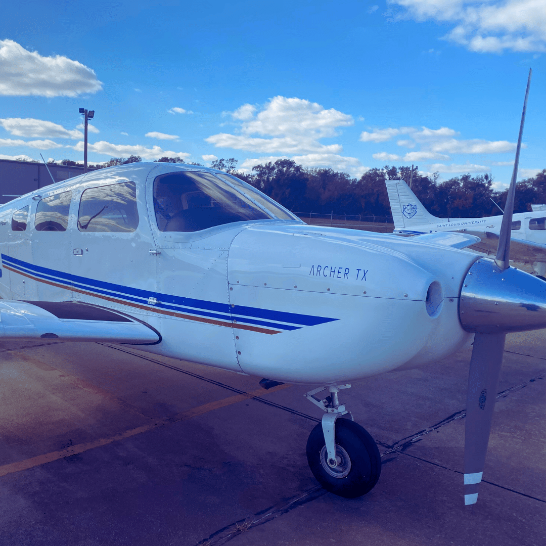 a small airplane parked on the tarmac at an airport